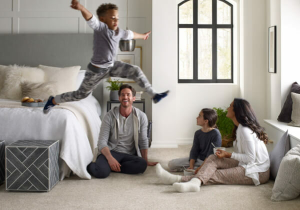 Family enjoying sitting on soft Carpet | Kay Riley Flooring and Design
