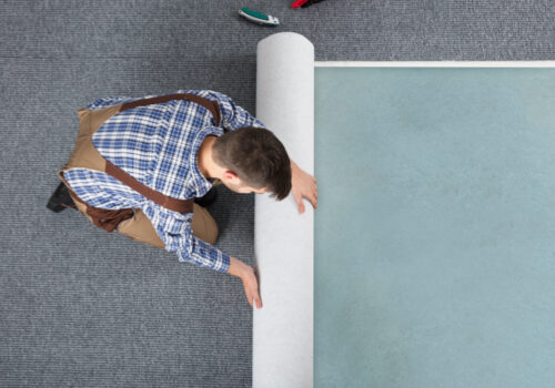 Man installing carpet | Kay Riley Flooring and Design